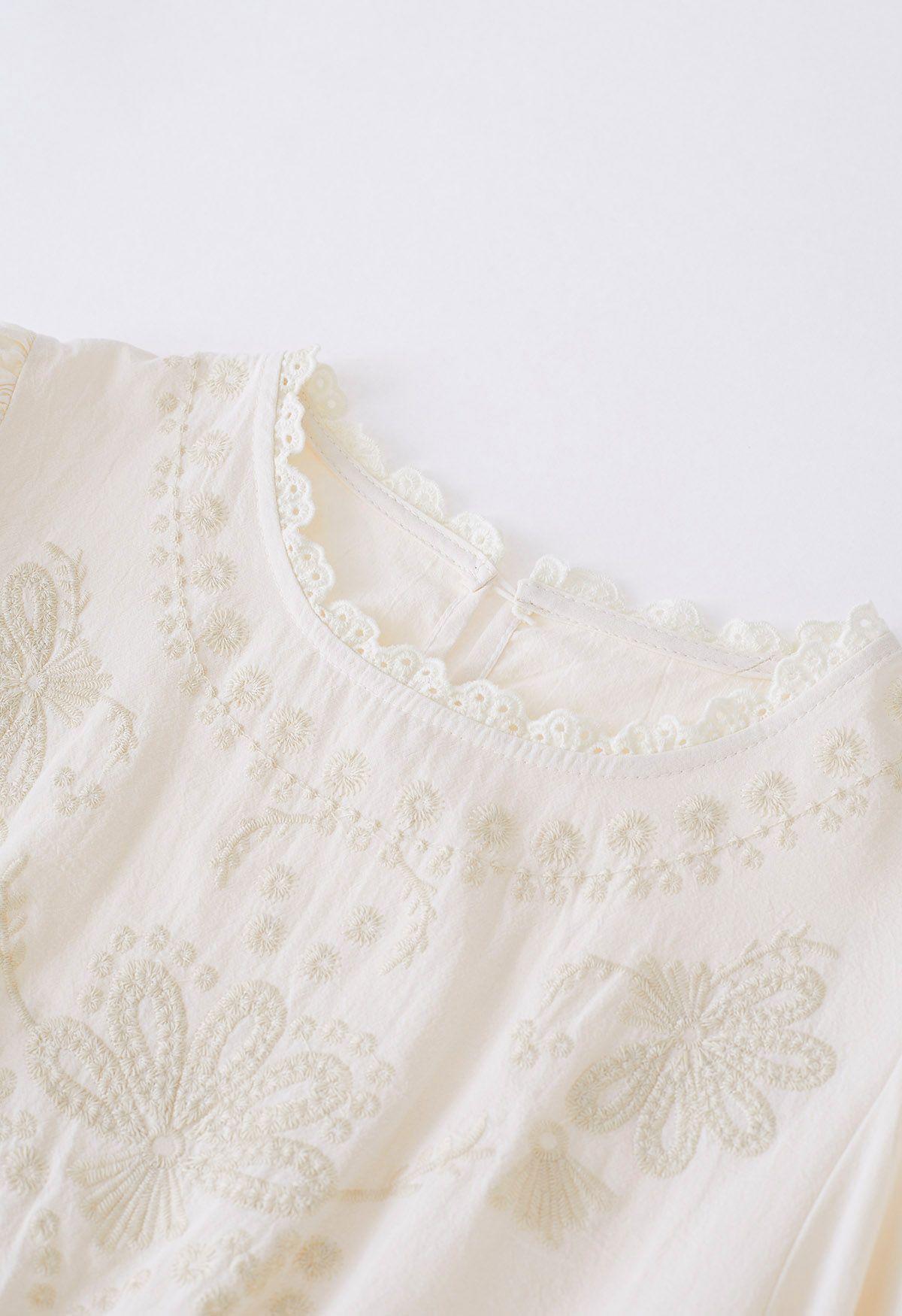 Scalloped Edge Floret Embroidery Peplum Top in Cream